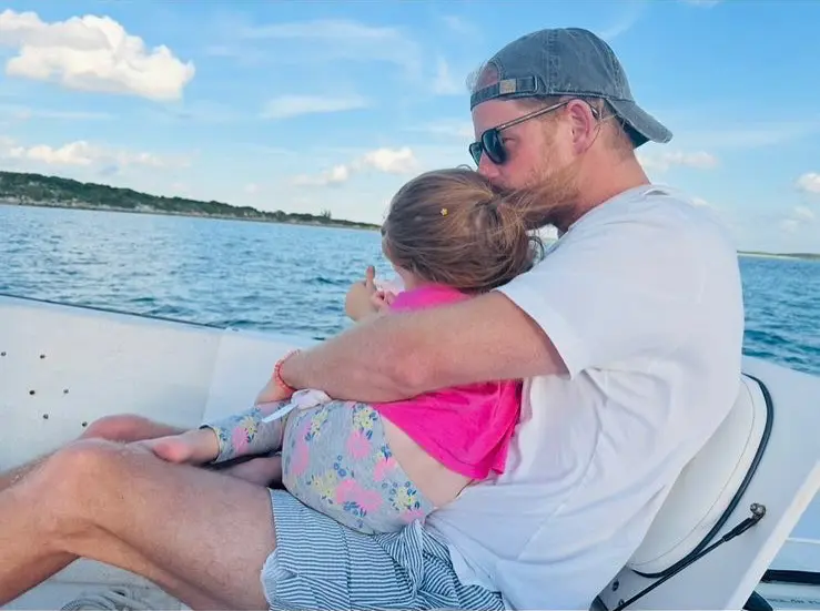 Markle released this photo of Harry cuddling Lili on a boat trip on her Instagram in March. Instagram / @meghan