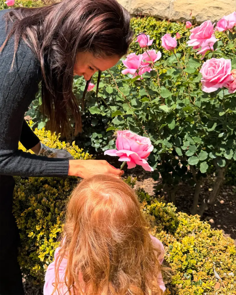 Markle posted a photo of her gardening and smelling roses with Lili.